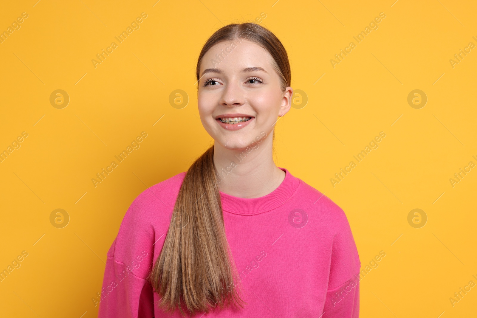 Photo of Portrait of teenage girl on yellow background