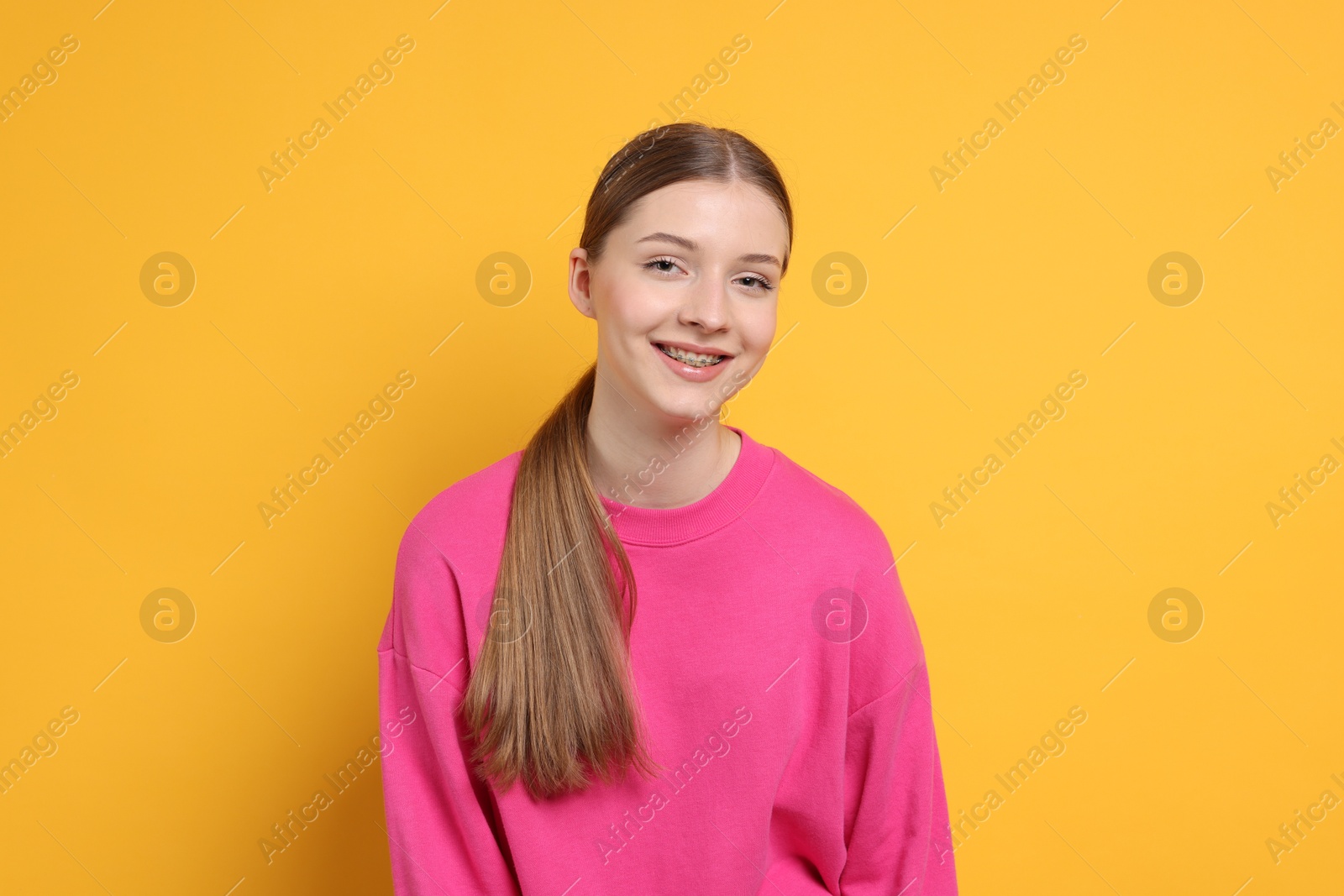 Photo of Portrait of teenage girl on yellow background