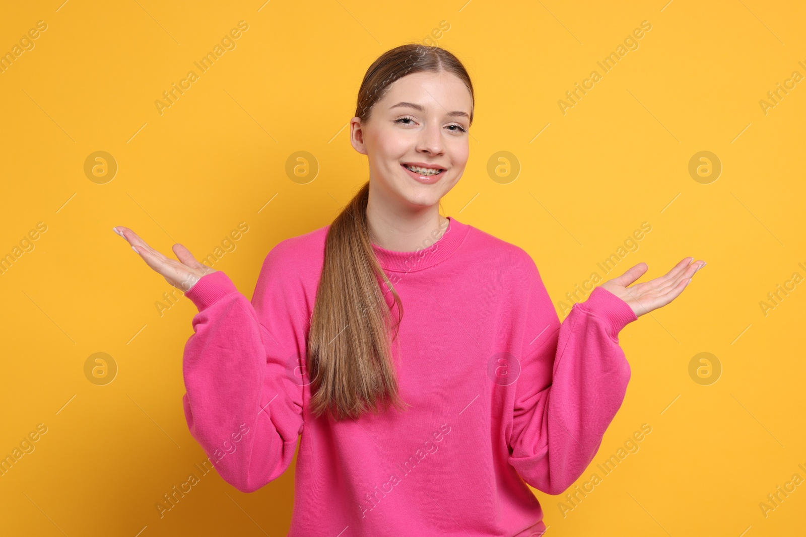 Photo of Portrait of teenage girl on yellow background