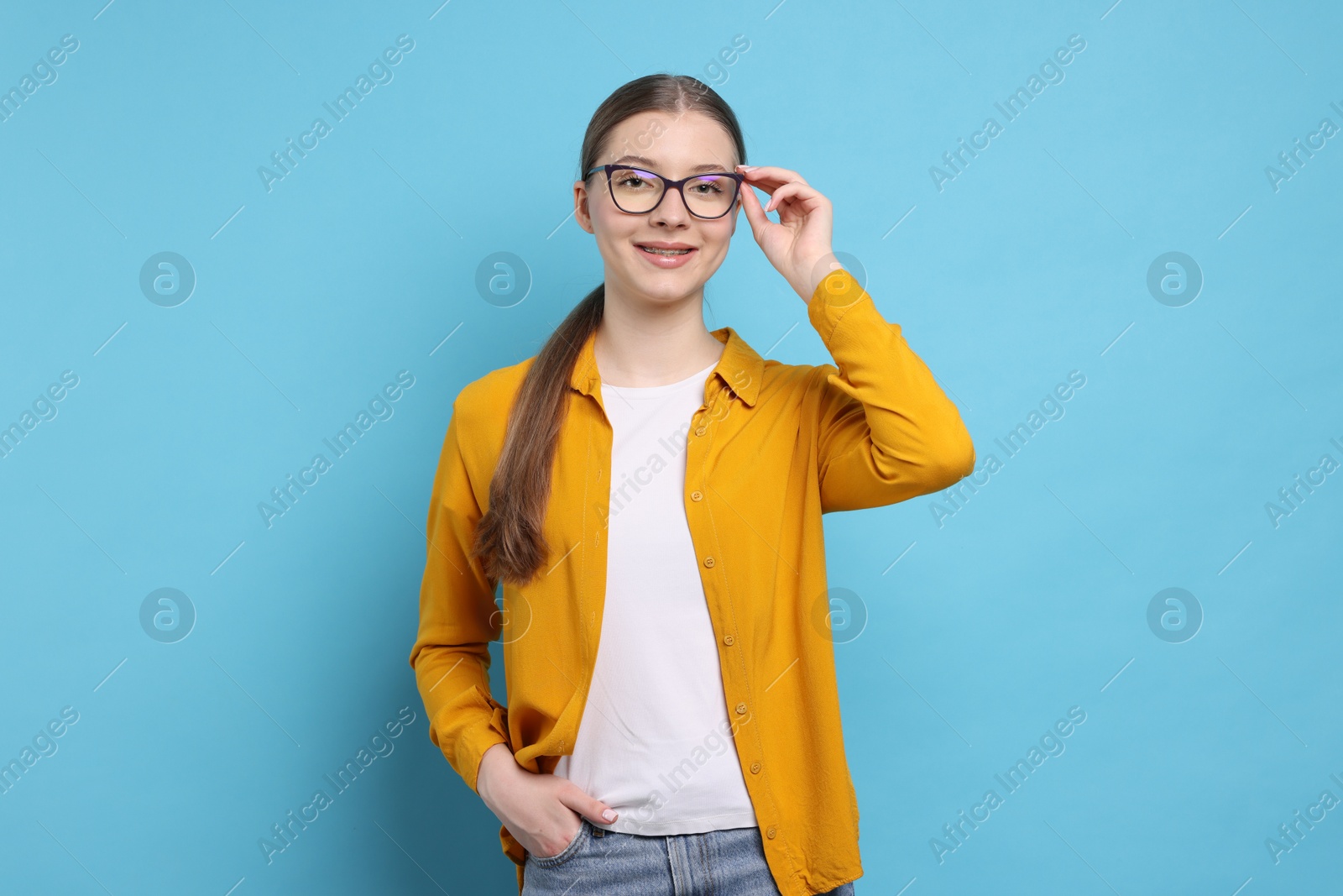 Photo of Portrait of teenage girl on light blue background