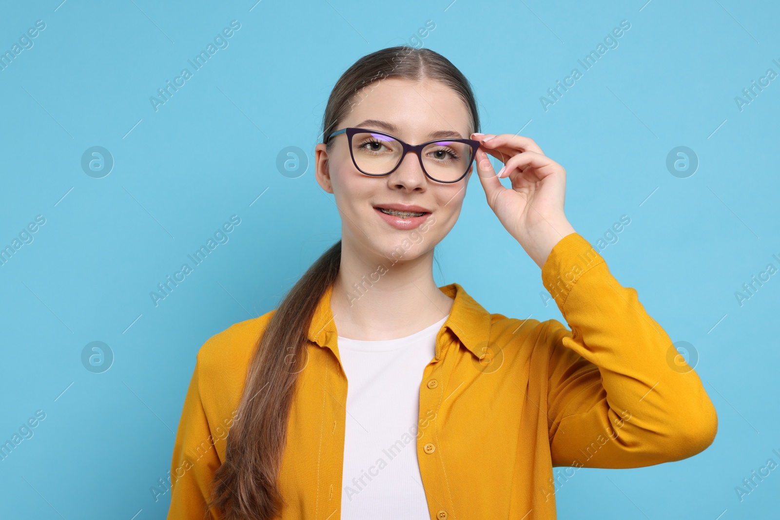 Photo of Portrait of teenage girl on light blue background