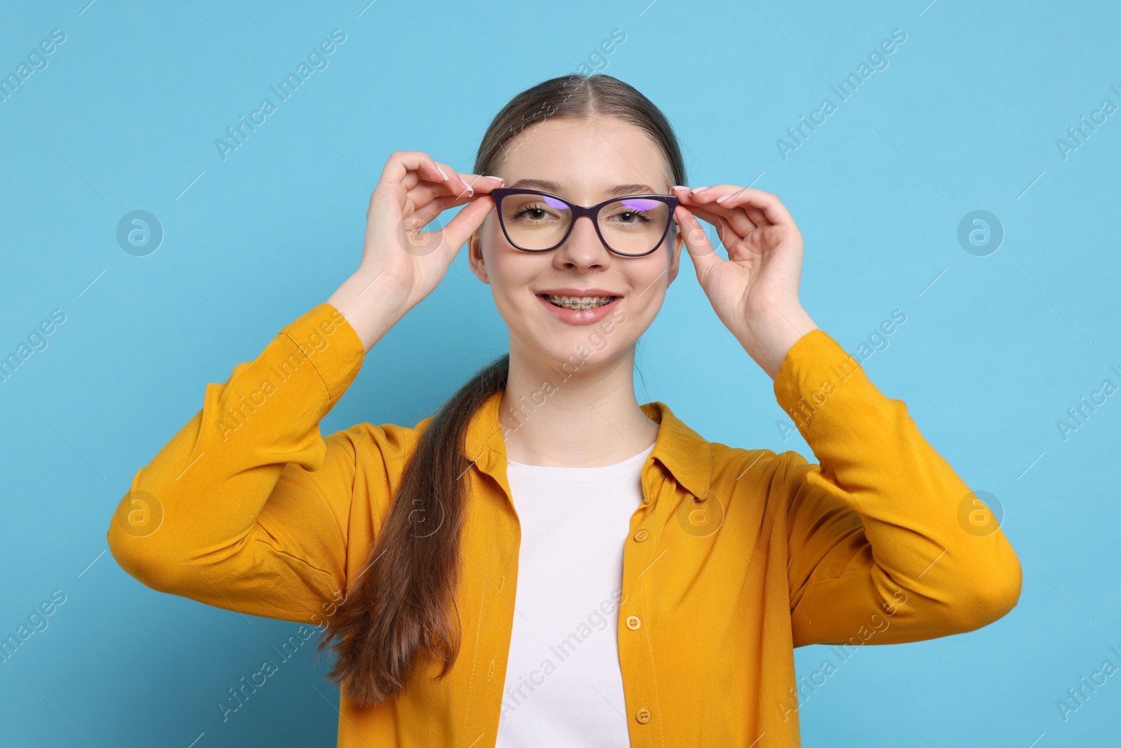 Photo of Portrait of teenage girl on light blue background
