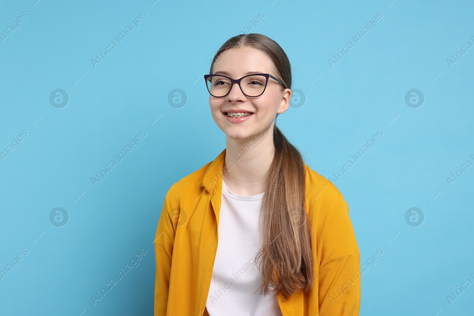 Portrait of teenage girl on light blue background Photo of Portrait of teenage girl on light blue background