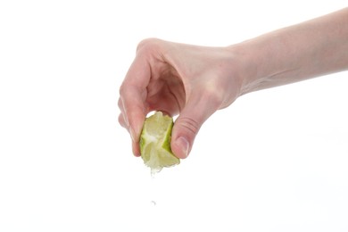 Photo of Woman squeezing lime on white background, closeup