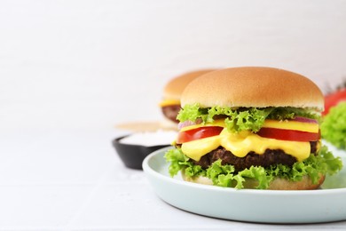 Photo of Tasty cheeseburger on white table, closeup. Space for text