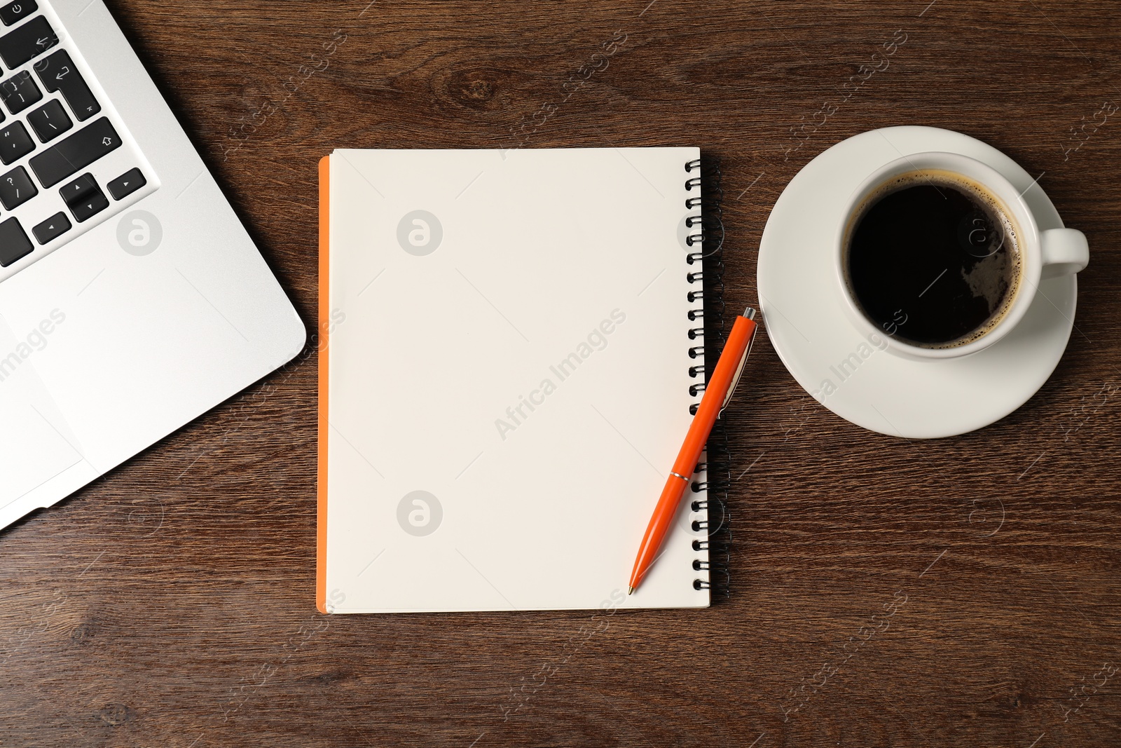 Notebook, pen, coffee and laptop on wooden table, flat lay Photo of Notebook, pen, coffee and laptop on wooden table, flat lay