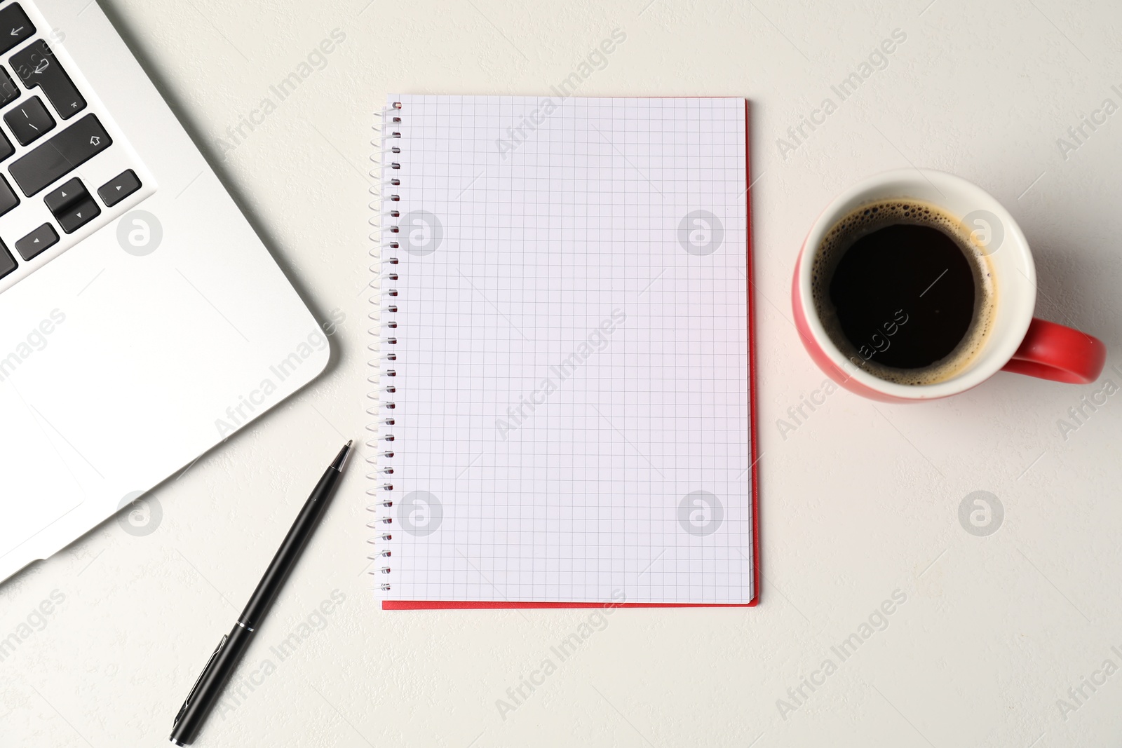 Photo of Notebook, pen, coffee and laptop on white table, flat lay