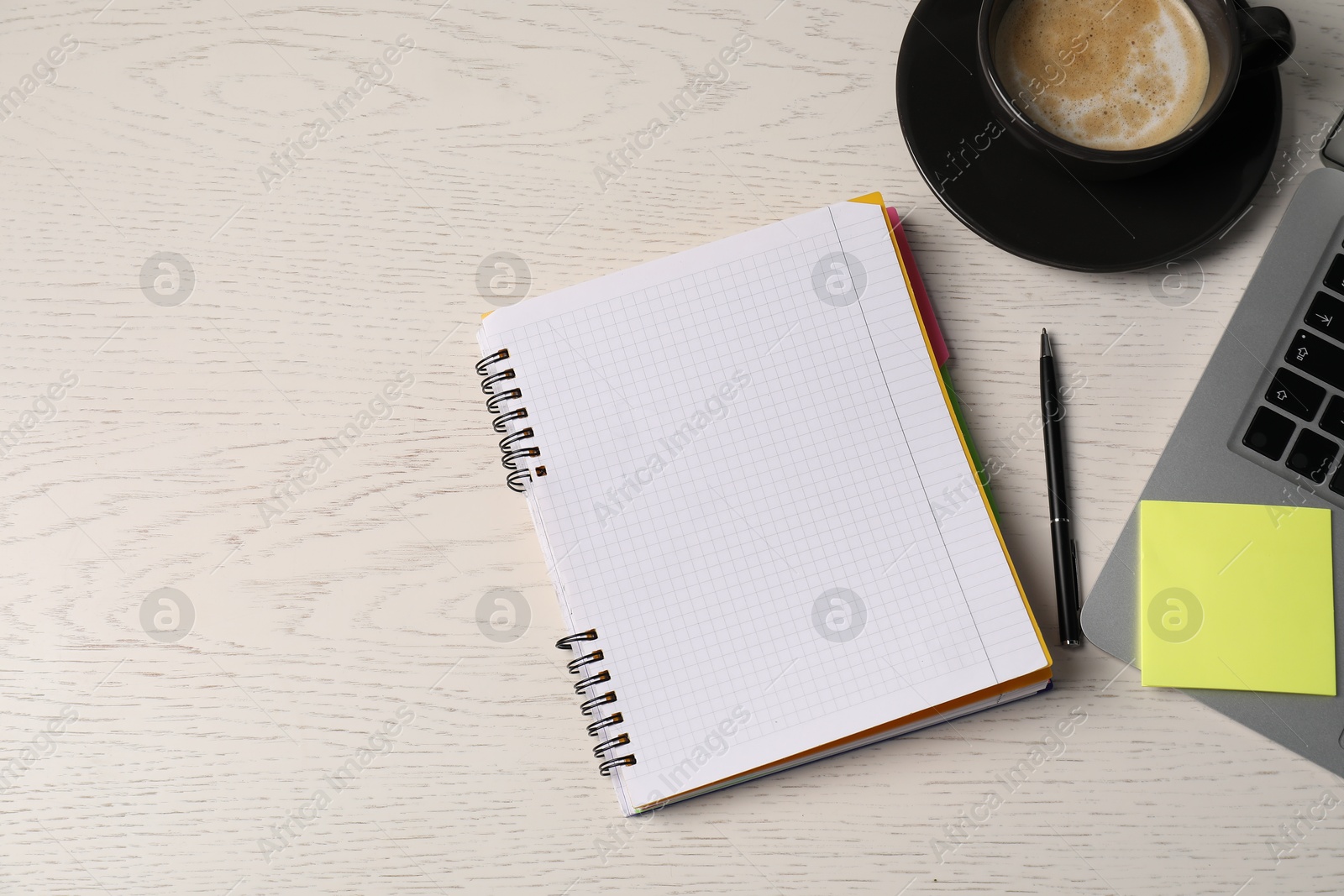 Notebook, sticky note, pen, coffee and laptop on white wooden table, flat lay. Space for text Photo of Notebook, sticky note, pen, coffee and laptop on white wooden table, flat lay. Space for text