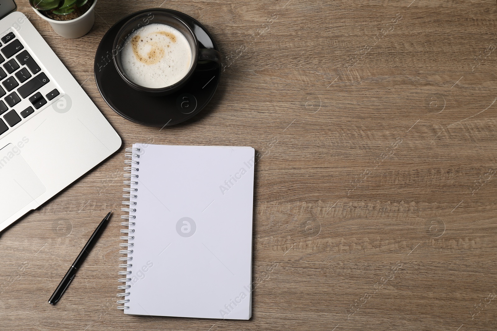 Photo of Notebook, pen, coffee and laptop on wooden table, flat lay. Space for text
