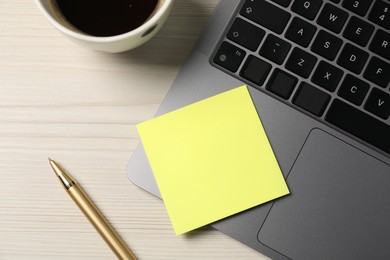 Photo of Sticky note, pen, coffee and laptop on wooden table, flat lay