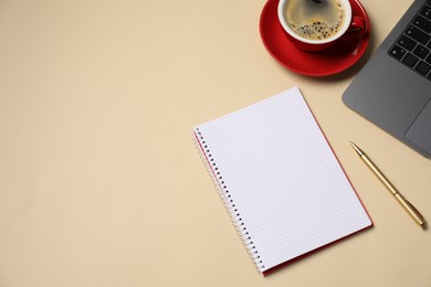 Photo of Notebook, pen, coffee and laptop on beige background, flat lay. Space for text