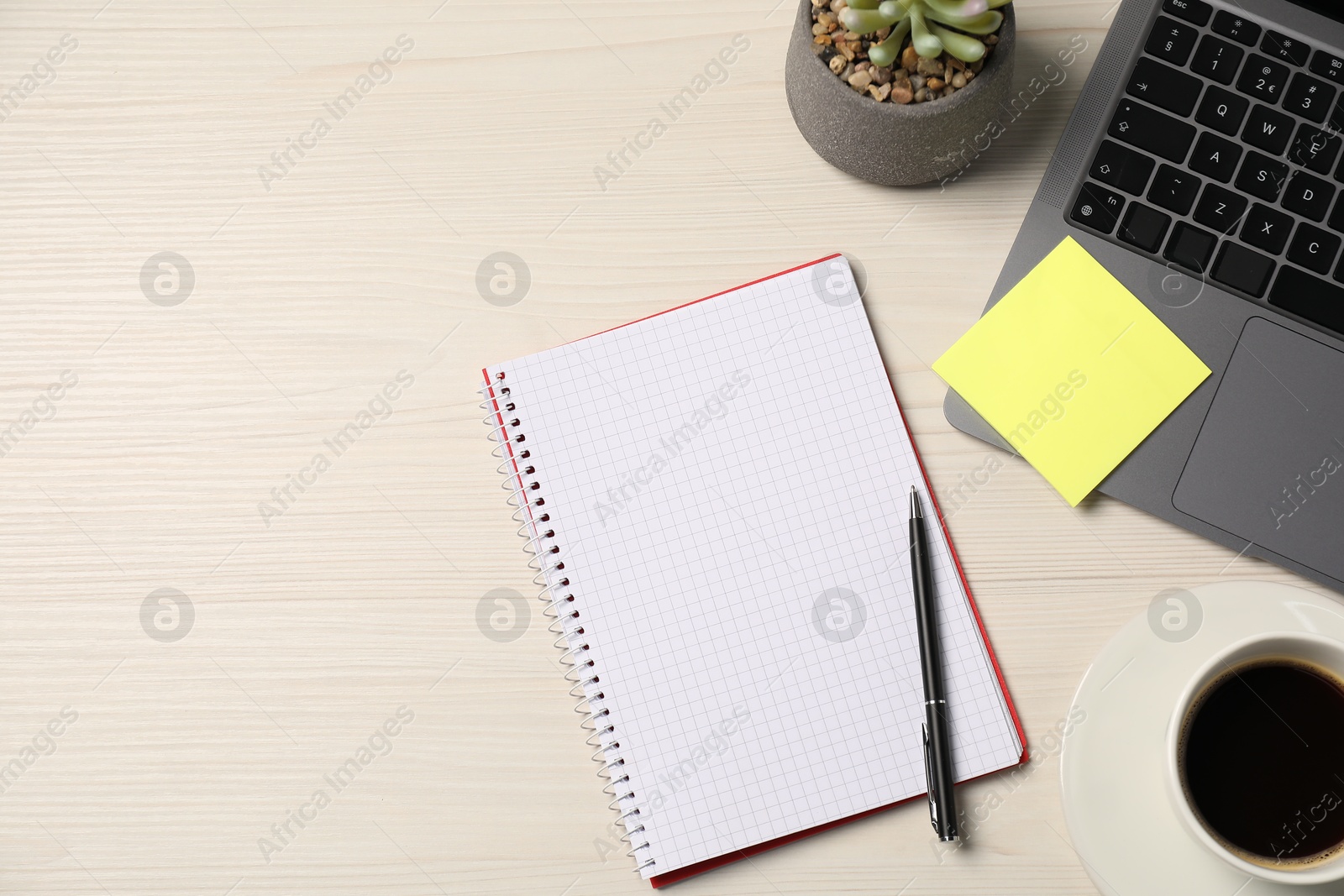 Notebook, sticky note, pen, coffee, floral decor and laptop on wooden table, flat lay. Space for text Photo of Notebook, sticky note, pen, coffee, floral decor and laptop on wooden table, flat lay. Space for text
