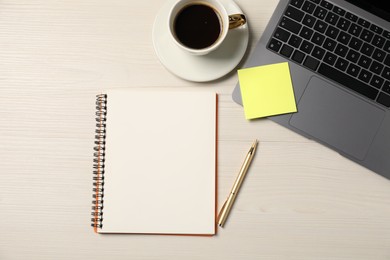 Photo of Notebook, pen, sticky note, coffee and laptop on wooden table, flat lay