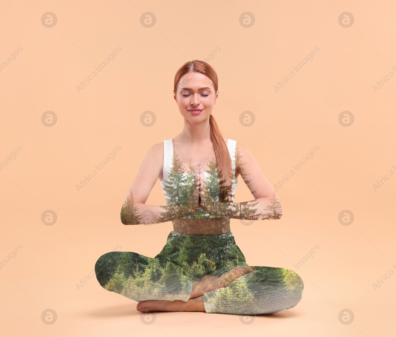 Young woman meditating during yoga practice on peach color background, double exposure with trees Image of Young woman meditating during yoga practice on peach color background, double exposure with trees