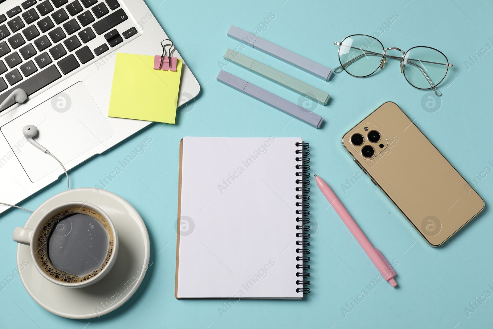 Notebook, other stationery, smartphone, coffee, glasses, earphones and laptop on light blue background, flat lay Photo of Notebook, other stationery, smartphone, coffee, glasses, earphones and laptop on light blue background, flat lay