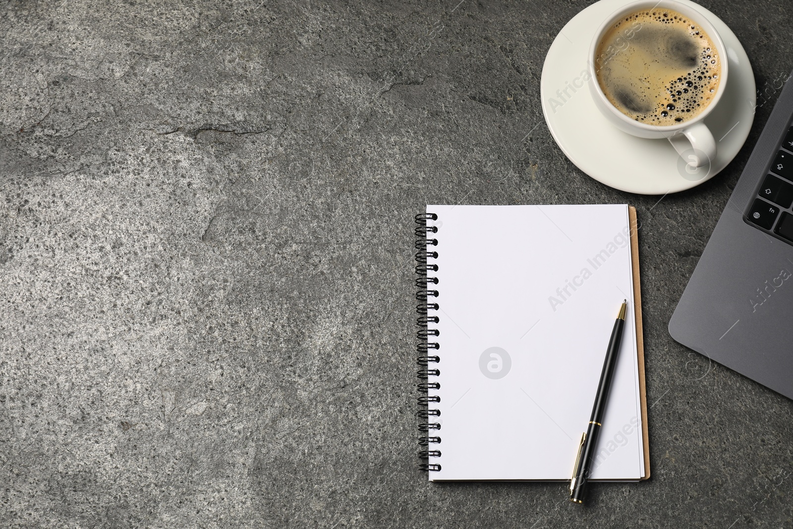 Notebook, pen, coffee and laptop on grey table, flat lay. Space for text Photo of Notebook, pen, coffee and laptop on grey table, flat lay. Space for text
