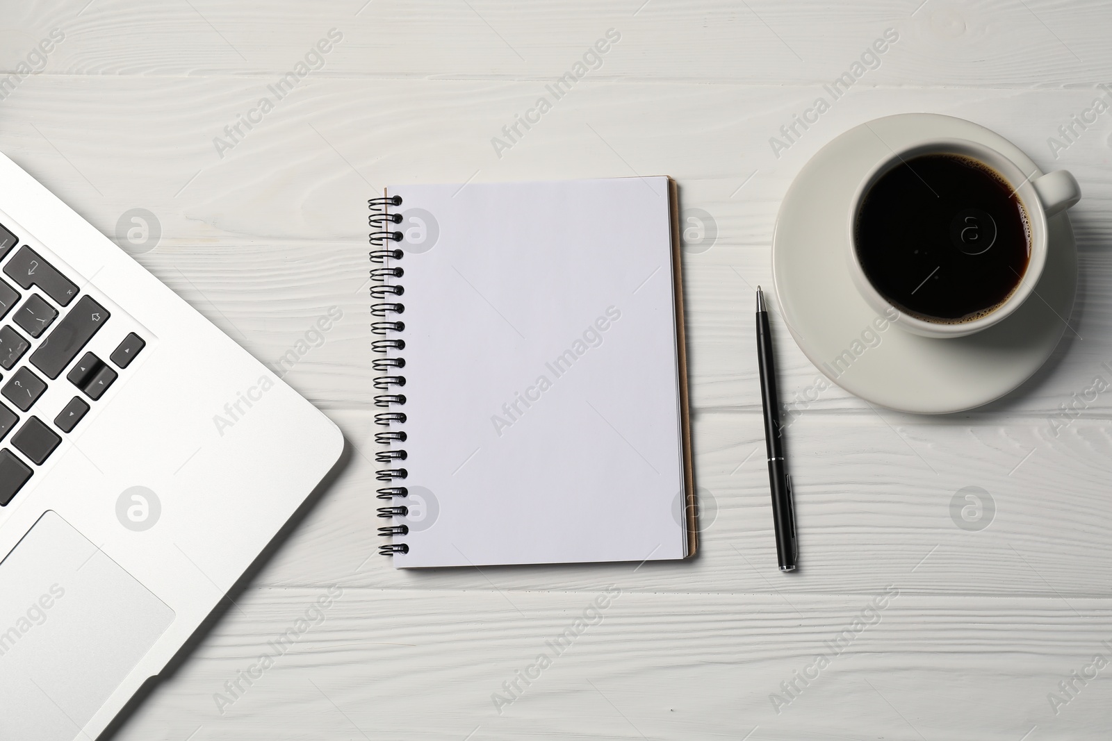 Notebook, pen, coffee and laptop on white wooden table, flat lay Photo of Notebook, pen, coffee and laptop on white wooden table, flat lay