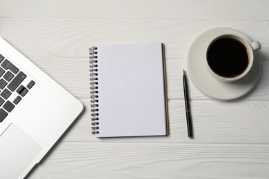 Photo of Notebook, pen, coffee and laptop on white wooden table, flat lay