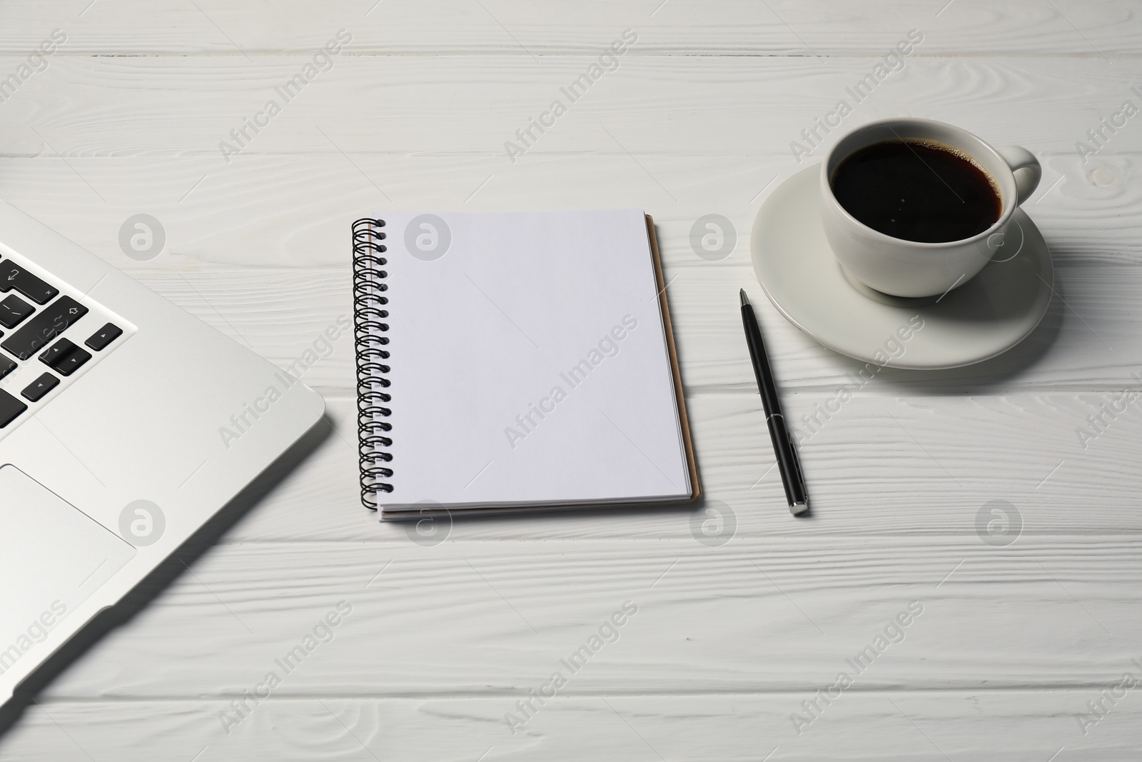 Notebook, pen, coffee and laptop on white wooden table Photo of Notebook, pen, coffee and laptop on white wooden table