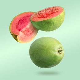 Image of Fresh guava fruits falling on light green background