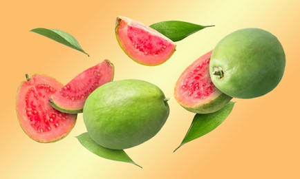 Image of Fresh guava fruits and leaves flying on pale orange background. Banner design