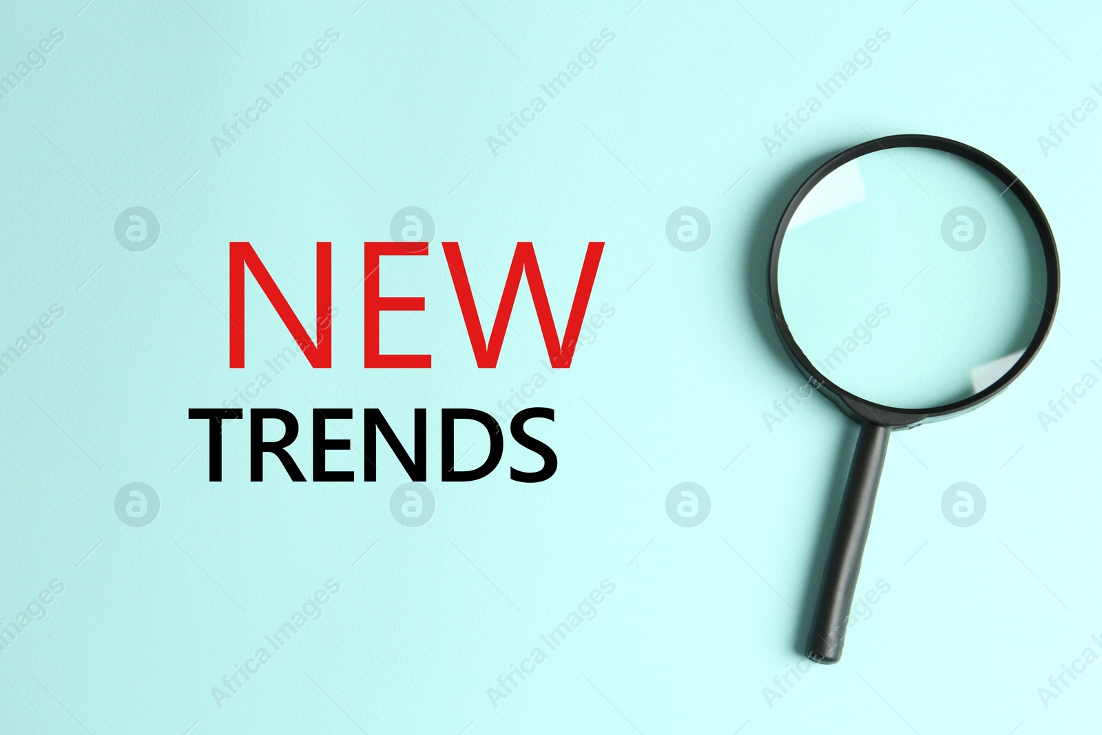 New trends. Magnifying glass on turquoise background, top view Image of New trends. Magnifying glass on turquoise background, top view