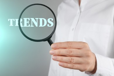 Image of Word Trends, view through magnifying glass in woman's hand