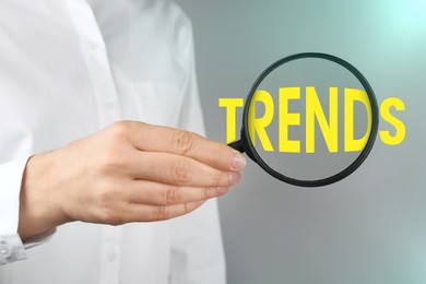 Image of Word Trends, view through magnifying glass in woman's hand