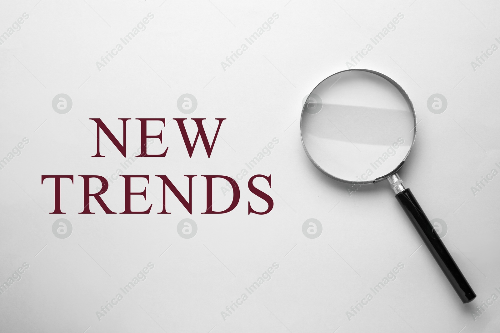 New trends. Magnifying glass on white background, top view Image of New trends. Magnifying glass on white background, top view