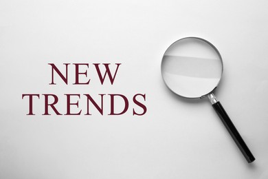 Image of New trends. Magnifying glass on white background, top view