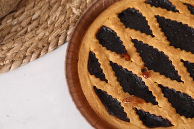 Photo of Cockroaches crawling on pie on light table, top view