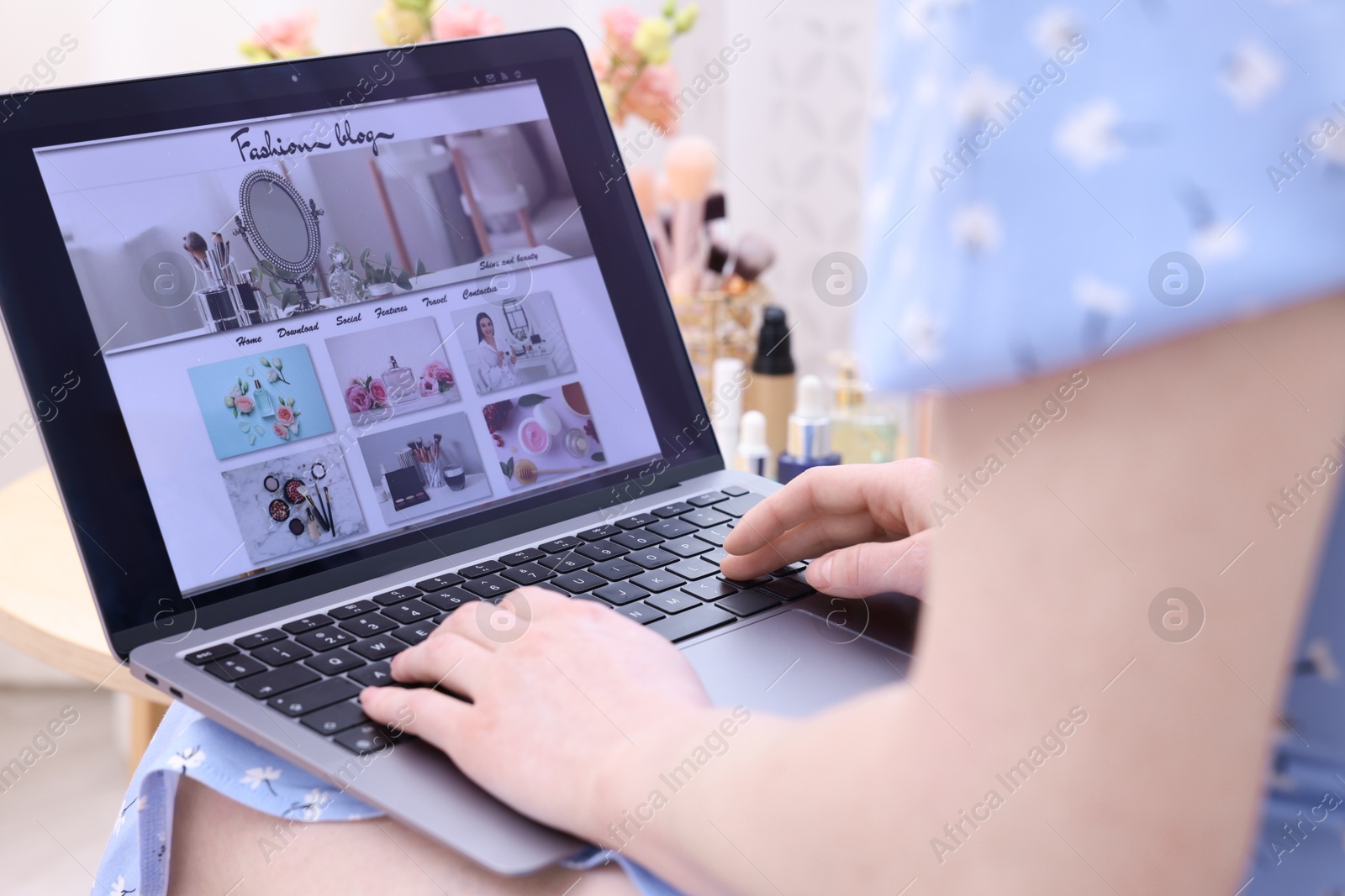 Blogger using laptop with fashion blog web site indoors, closeup Photo of Blogger using laptop with fashion blog web site indoors, closeup