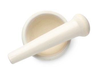 Photo of Ceramic mortar with pestle isolated on white, top view