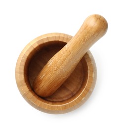 Photo of Wooden mortar with pestle isolated on white, top view