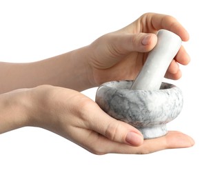 Photo of Woman with mortar and pestle on light background, closeup