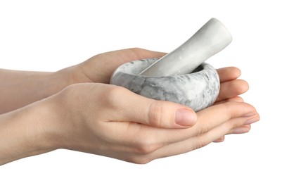 Photo of Woman with mortar and pestle on light background, closeup