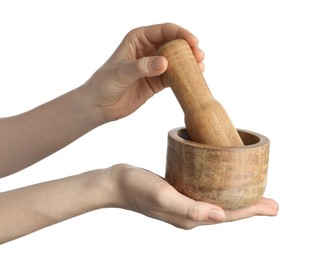 Photo of Woman with mortar and pestle on light background, closeup