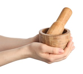 Photo of Woman with mortar and pestle on light background, closeup