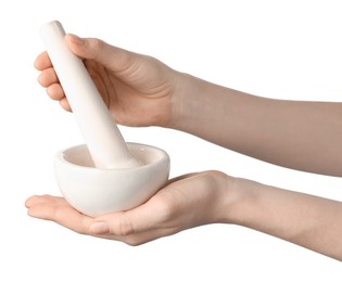 Photo of Woman with mortar and pestle on light background, closeup