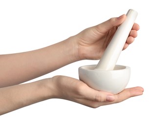 Photo of Woman with mortar and pestle on light background, closeup
