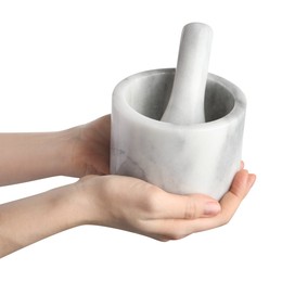 Photo of Woman with mortar and pestle on light background, closeup