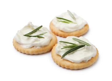 Photo of Tasty crackers with cream cheese and rosemary isolated on white