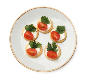 Photo of Tasty crackers with cream cheese, tomatoes and parsley isolated on white, top view