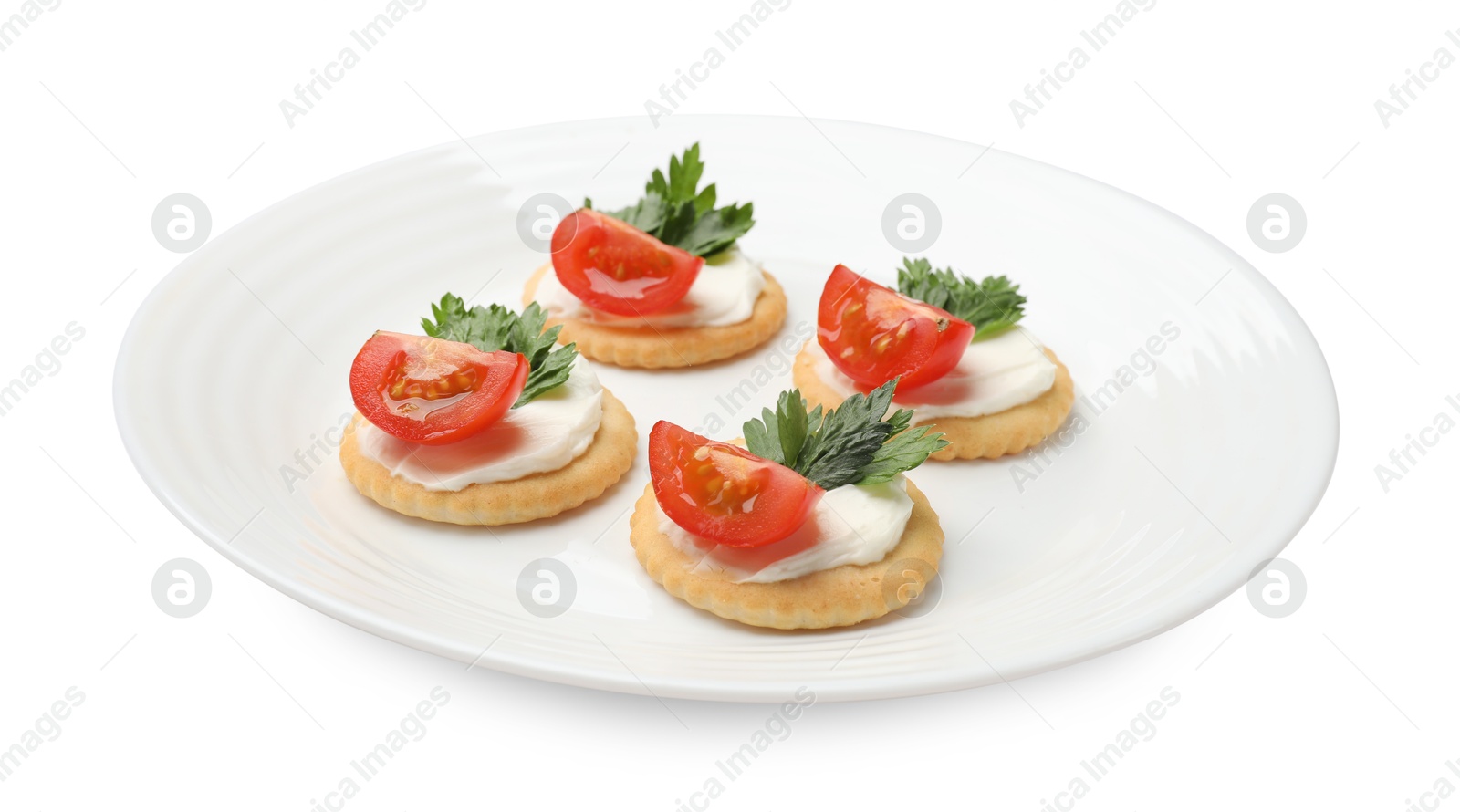 Photo of Tasty crackers with cream cheese, tomatoes and parsley isolated on white