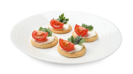 Photo of Tasty crackers with cream cheese, tomatoes and parsley isolated on white