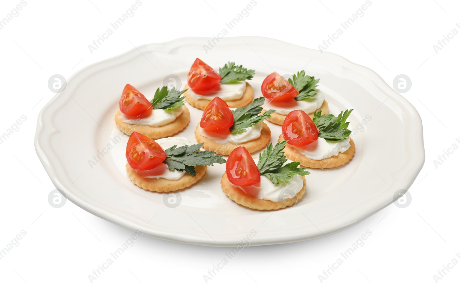 Photo of Tasty crackers with cream cheese, tomatoes and parsley isolated on white