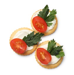 Photo of Tasty crackers with cream cheese, tomatoes and parsley isolated on white, top view