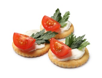 Photo of Tasty crackers with cream cheese, tomatoes and parsley isolated on white