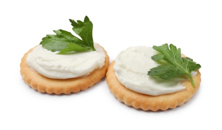 Photo of Tasty crackers with cream cheese and parsley isolated on white