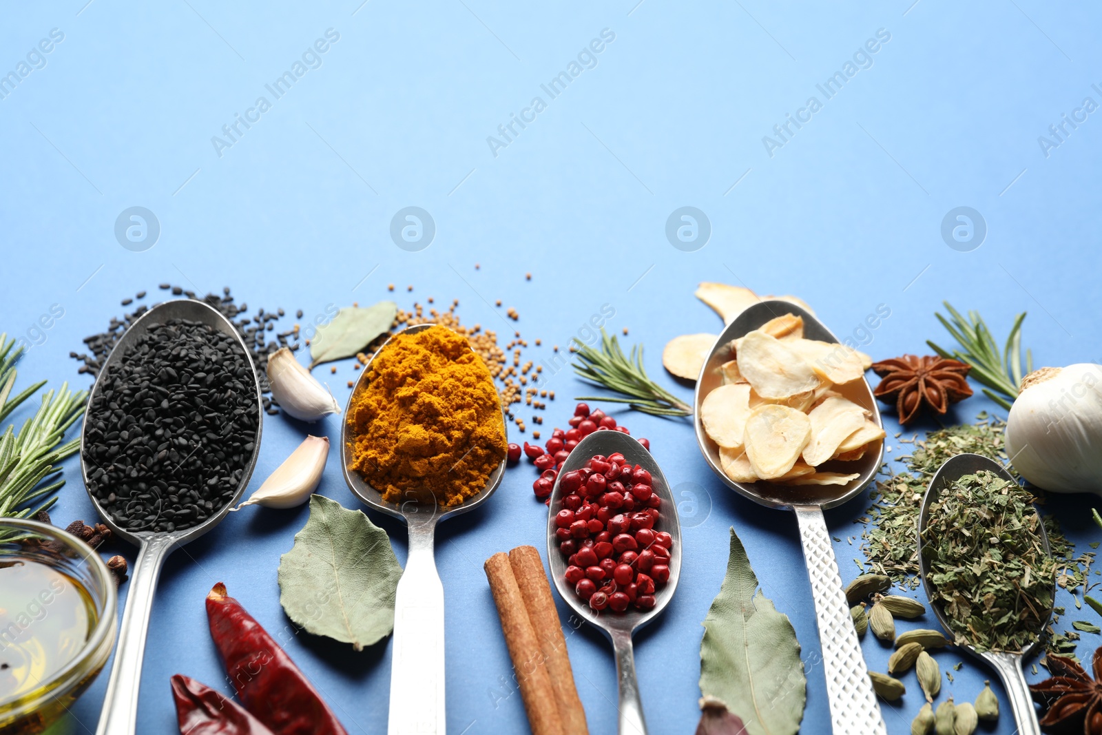 Different aromatic spices on blue background. Space for text Photo of Different aromatic spices on blue background. Space for text